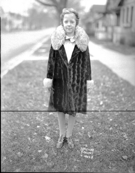 Katherine Verikios, 10, 1135 E. Mifflin Street, wearing fur-trimmed coat. She won the Madison Label Saving contest and received a new Chevrolet.