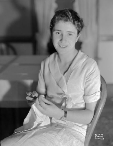 Marian Dolan, of the Maple Knoll 4-H club north of Sun Prairie, 1931 National 4-H champion, sewing.