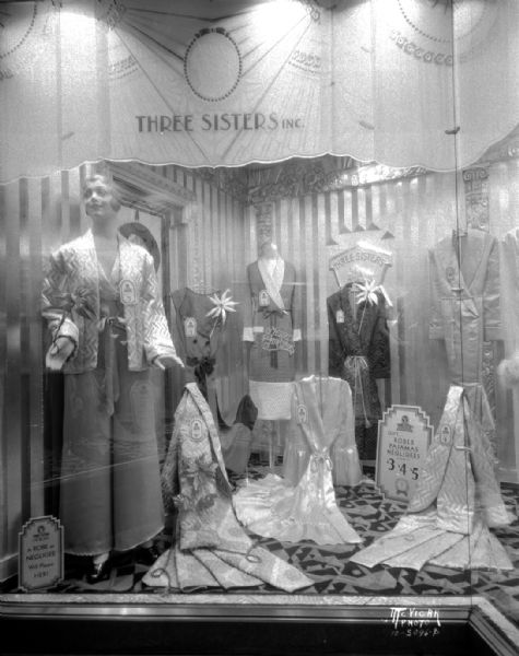 Christmas window display, Three Sisters Clothing Store, Tenney Building, of women's robes, pajamas, negligees, 27 S. Pinckney Street.