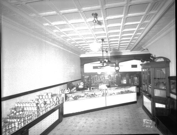 University of Wisconsin Meat Market interior, showing counters with meat, and display cases and coolers in rear.