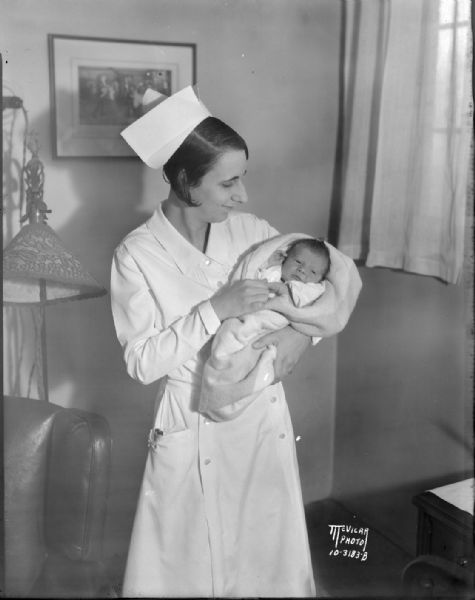 First baby born at Methodist Hospital, 1932, 309 W. Washington Avenue. Nurse Mrs. Gorden L. Fredendall is holding Brunell Winston Ethun.
