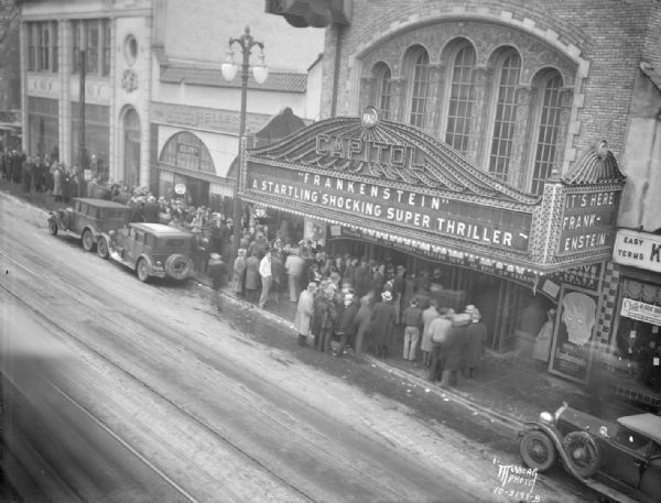 Elevated view of a crowd lined up to see "Frankenstein" at the Capitol Theatre, 209-11 State Street. Next door is Kessenich's, at 201 State Street, and Heller's, at 205 State Street.