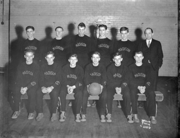 Group portrait of the Central High School basketball squad and coach.