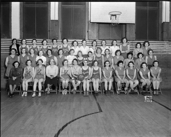 Group portrait of members of the Madison Industrial Girls' Basketball League sponsored by the Board of Education, Department of Recreation.  Kresge's Five and Ten defeated the Multichrome Cardinals for the championship in Lincoln School gymnasium.