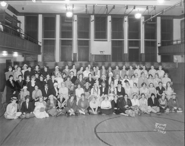 Group portrait of women's club party at the Lincoln school gymnasium.