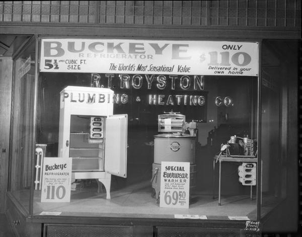 Display window at R.T. Royston Plumbing and Heating, 1325 University Avenue. On display is a Buckeye refrigerator and Everwear washer.