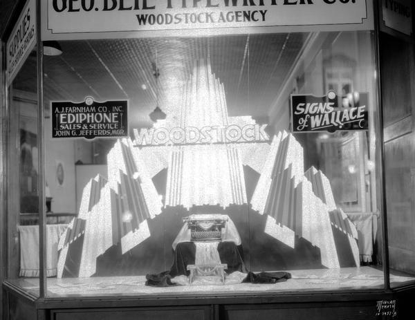 George Beil Typewriter Co., 1454 Williamson Street, window display, with Woodstock typewriters featured.