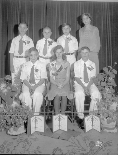 Sherman Park School, 1601 North Sherman Avenue, eighth grade graduates, five boys, one girl, and teacher. Floral arrangements and programs are featured.