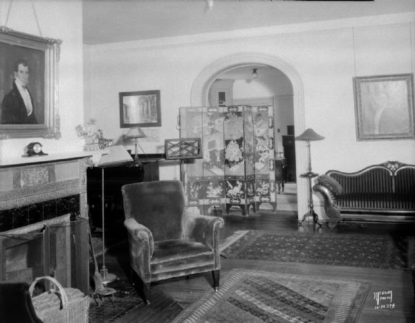 Living room of the Carl & Jeanne Fish residence, 511 N. Carroll Street, with oriental screen and fireplace.