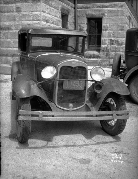 Front view of damaged Ford sedan which struck and injured Herbert Lindauer. Taken for his brother A.C. Lindauer Insurance Agency.