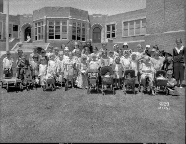 Children in costume for doll buggy and coaster wagon parade at Dudgeon School.