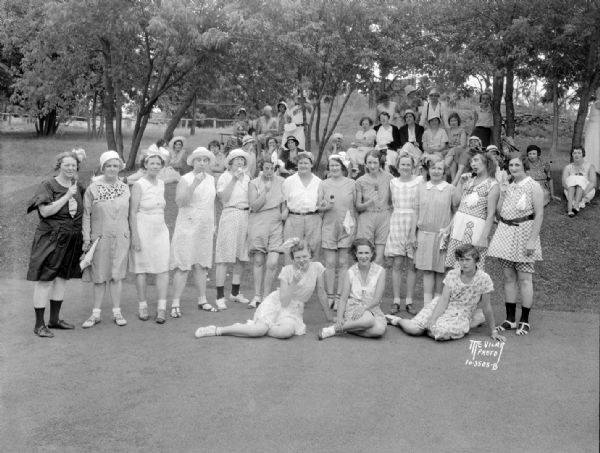 Blackhawk Country Club dress up day for women titled "Children's Day." Women are dressed in children's costumes and are eating ice cream cones.