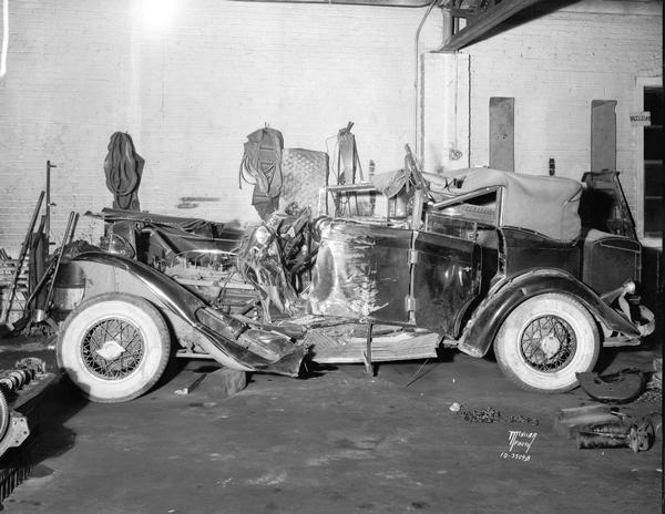 Wrecked Auburn Phaeton car indoors at Badger Motors garage, 1501 Monroe Street.