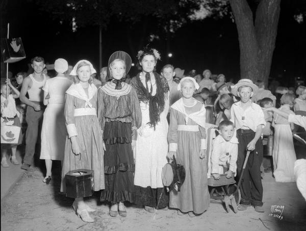 Group portrait of children dressed as pioneers for a Lantern Parade.