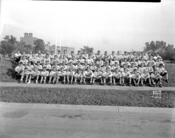 Outdoor group portrait of the East High School football squad in uniform.