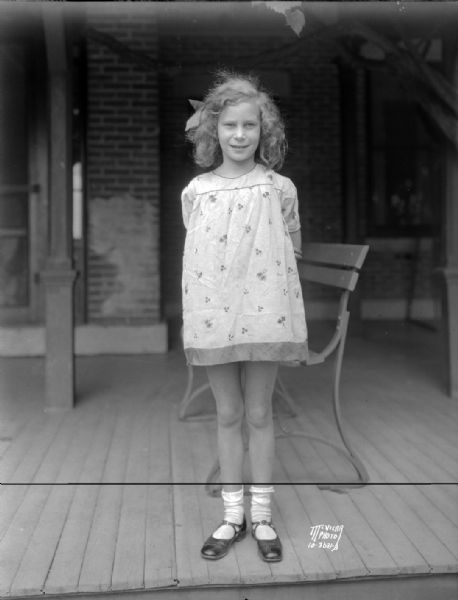 Portrait of Marian Montana Wheeler, daughter of Mrs. Burton Wheeler, of Butte Montana, taken on the porch of the La Follette farmhouse at Maple Bluff. She was named for the senior La Follette.