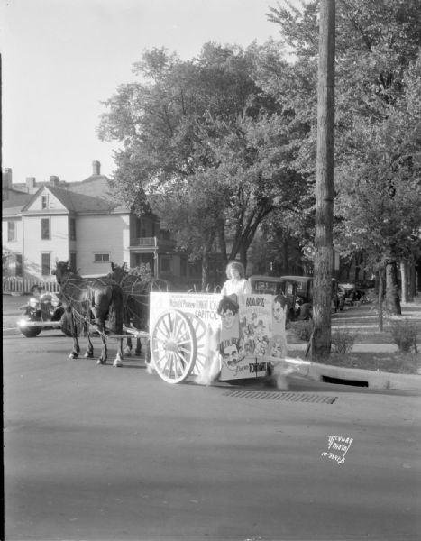 Horse-drawn cart advertising "Horsefeathers," a Marx Brothers movie, for the RKO Orpheum Theatre. "Mad Mirth takes a chariot ride among the wild oats."