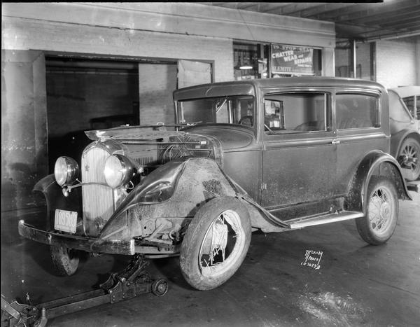 Wrecked Plymouth automobile at Kelly's Motor Service Garage, 25 W. Doty Street.