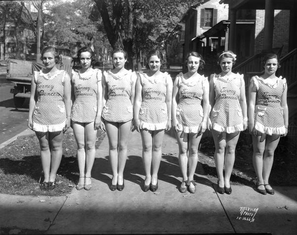 Seven Fanchon and Marco showgirls in "Torney Dancers" costumes standing on the sidewalk. They are performing "Stitch in Time Idea."