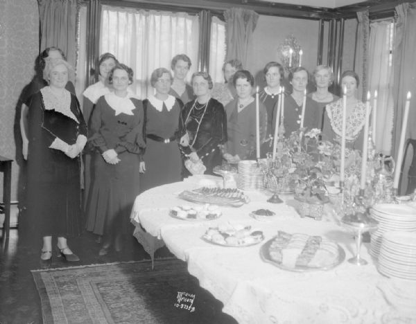 University League benefit bridge tea hostesses around the tea table in the dining room at the University of Wisconsin Pres. Glenn Frank's home, 130 N. Prospect Avenue.