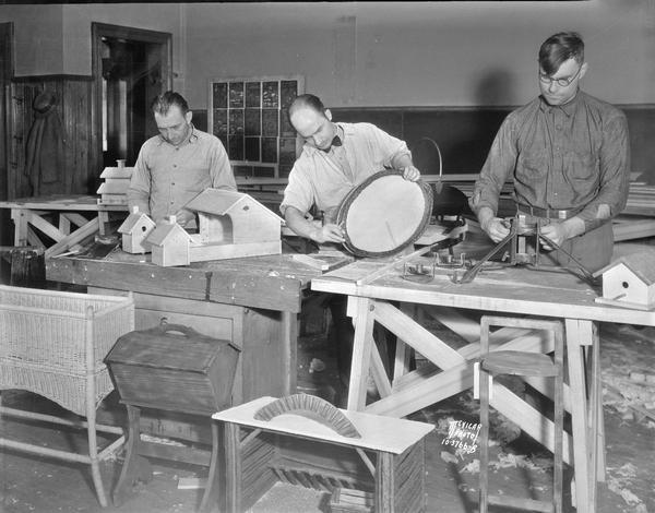 Jobless workers in the Vocational School class working on their crafts projects, O.W. Smith, Lewis A. Russett, Rudolph Beckman.