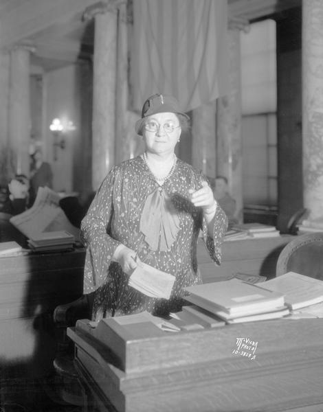 Portrait of Mary O. Kryzsak, Wisconsin's only assembly woman, speaking from her desk in the Assembly.