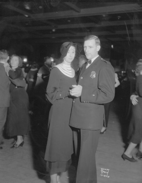 Charles O. Burmeister, general chairman of the event, dancing with Miss Florence Huston, at Policemen's ball, East High School.