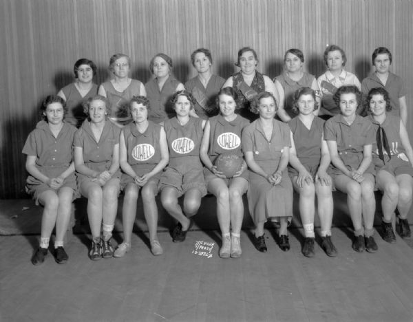 Group portrait of Lowell school women's championship soccer baseball team in uniform.