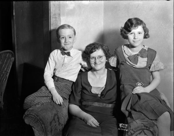 Mrs. Emma Grahn, 57 Wirth Court, Madison's first woman justice of the peace, with her two children: Lucille, 10, and Warren, 9.