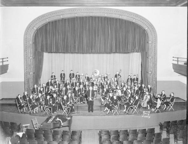 Elevated view of the combined Madison Central High School Band and Orchestra under the proscenium arch.