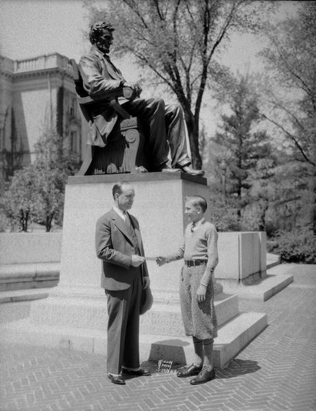 University of Wisconsin President Glenn Frank presenting $4,500 Emily Jane Culver Scholarship to Charles Pfeiffer of Racine. They are standing next to the Lincoln Monument on Bascom Hill. Charles Pfeiffer was the Wisconsin winner of the three year scholarship to the Culver Military Academy in Culver Indiana. After graduating from Culver in 1936 he graduated from the University of Chicago in 1941. He was killed in action in Germany in 1944.