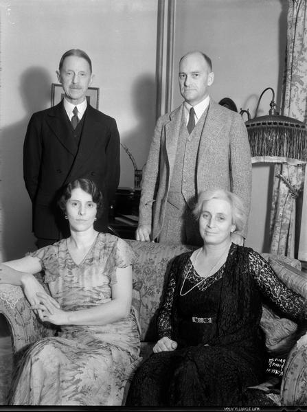 Group portrait of Sir Francis and Lady Wylie with Prof. Chester V. and Mrs. Norma Easum taken in the Easum home, 1715 Jefferson Street. Standing l to r: Sir Francis Wiley and Prof. Chester Easum; sitting l to r: Mrs. Norma Easum and Lady Wiley. Sir Francis was the Oxford secretary for the Rhodes Trust and was responsible for the Oxford administration of the Rhodes scholarships for the first 25 years.