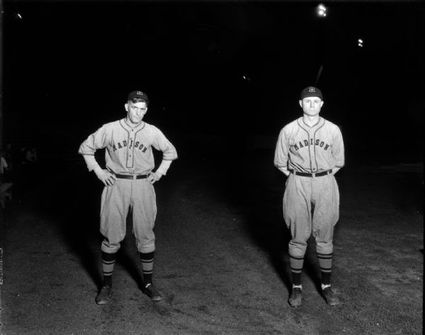 Portraits of two Madison Blues baseball players in uniform, Bill Goff, standing with hands behind his back and "Skipper" Manager Eddie Lenahan, standing with hands on hips.