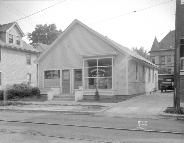 Volunteers of America Service Office and Service Shop, 414 S. Baldwin Street. Also shows the old Marquette School in the background.