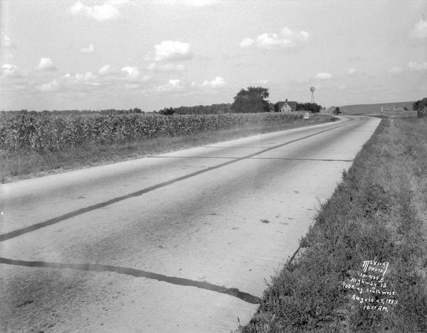 US Hwy 12 looking southwest, showing corn fields, McVicar Photo Service case, Sinclair sign and a good view of farm buildings in the background.