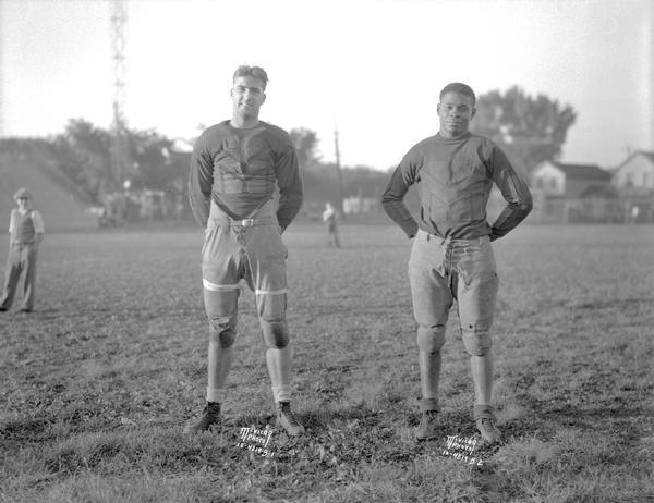 Two Central High School football players. 4219B-1 is unknown. 4219B-2 is Ernie Mitchell, who is African American.