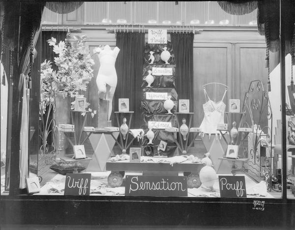 Burdick and Murray display window showing "Wiff 'n' Pouff Sensation" corsets. "Smartens Young Lines." 15-19 E. Main Street.