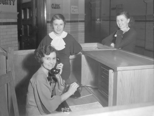 Dane County Court House "telephone girls" at the new switchboard. Sitting at the switchboard is Madge Albright, and in the rear is Bernadine Plachy and Mary Davis.