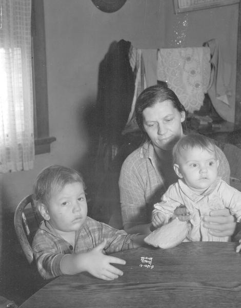 Aranka Martinelli with two of her eight children. Her husband, Felix, obtained employment through the CWA (Civil Works Administration) program.