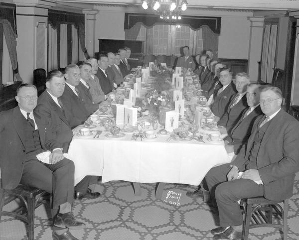 The seventeen members of "Tom" Jones club honored T.E. Jones, Wisconsin track coach, at a surprise banquet at the Loraine Hotel.