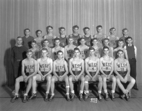 Group portrait of West High School boy's basketball team in uniform.