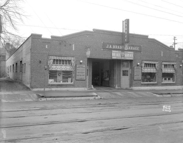 View across street towards the J.A. Brady Garage, 1307 Williamson Street, owned by John A. Eichman, specializing in brake service. Joseph A. "Doc" Brady died in 1931. John Eichman became manager.