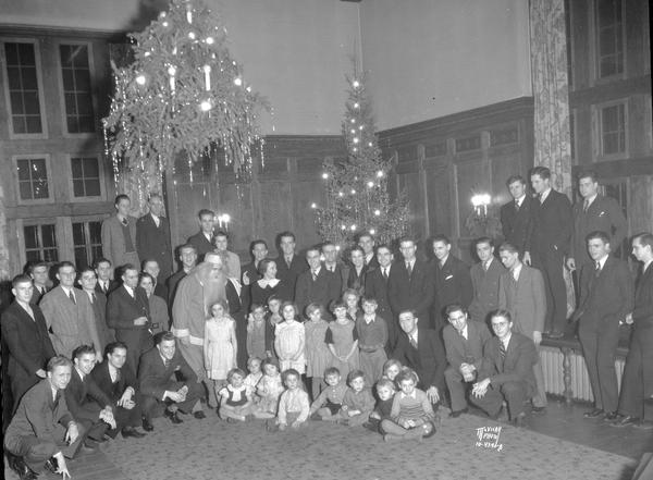 Phi Gamma Delta children's Christmas party, 16 Langdon Street. Group portrait of members and seventeen children cared for by the Salvation Army.