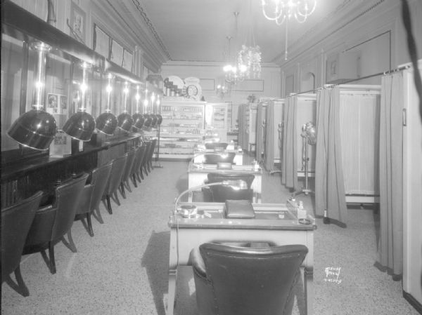 Cardinal Beauty Shoppe, 625 State Street, interior view from the front of the shop. Featuring the dryer system and manicure tables.