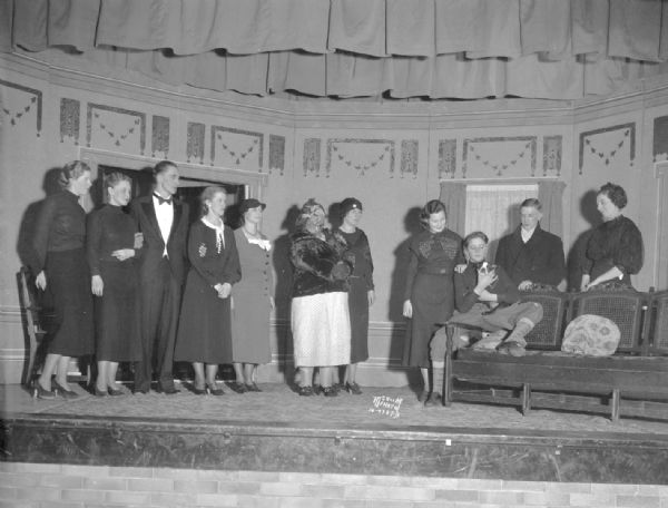 DeForest Mother's Club cast, in costume and on stage, for "Elmer," a winning play for the Dane County play contest. Cast: Donald Anderson, Jean Grinde, Lorraine Moran, Ruth Tweten, Olga Gest, Henrietta Halsor, Clara Boehm, Bob Sorenson, Clifford Harm.