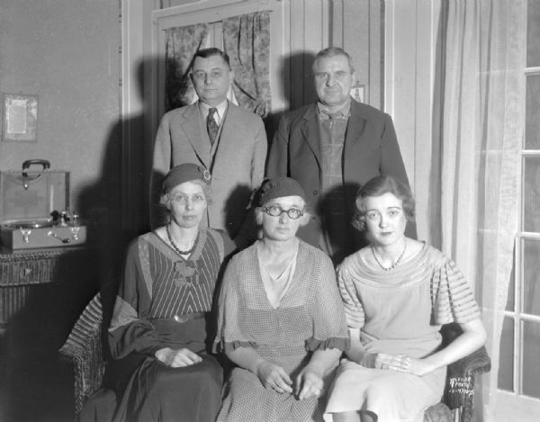 Group portrait of three women and two men who are in the Badger theater group in Mt. Horeb participating in the Dane County rural drama tournament. Left to right seated: Mrs. Chester Wilcox, Mrs. A.C. Sundstrom, and Marian Anderson. Left to right standing:  F.W. Huels, Chester Wilcox.