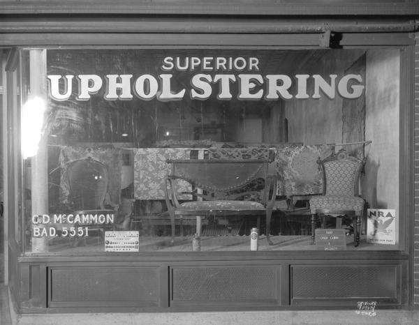 Furniture and fabrics in Charles D. McCammon "Superior Upholstering" display window, 851 East Johnson Street, with National Recovery Administration sign.