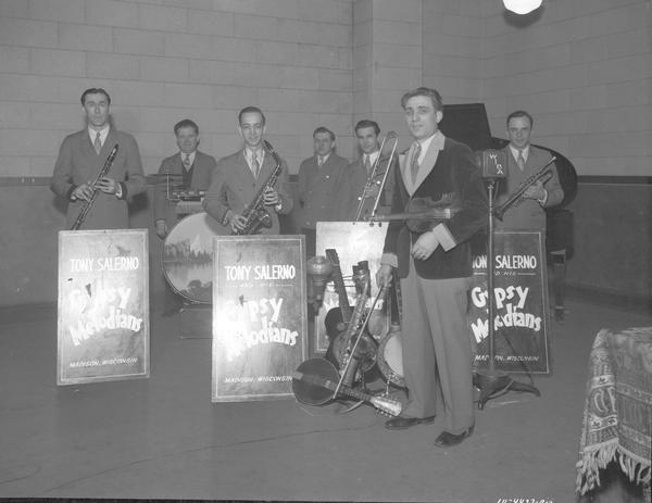 Tony Salerno and his Gypsy Melodians, six musicians. Tony Salerno, leader, is standing with instruments at the WIBA studio.