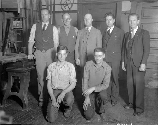 Wisconsin Engraving Co., 109 S. Carroll Street. Group portrait of seven men.