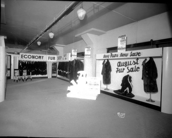 Hill's Dry Goods Company, 202 State Street, fur coat department, showing racks of fur coats.